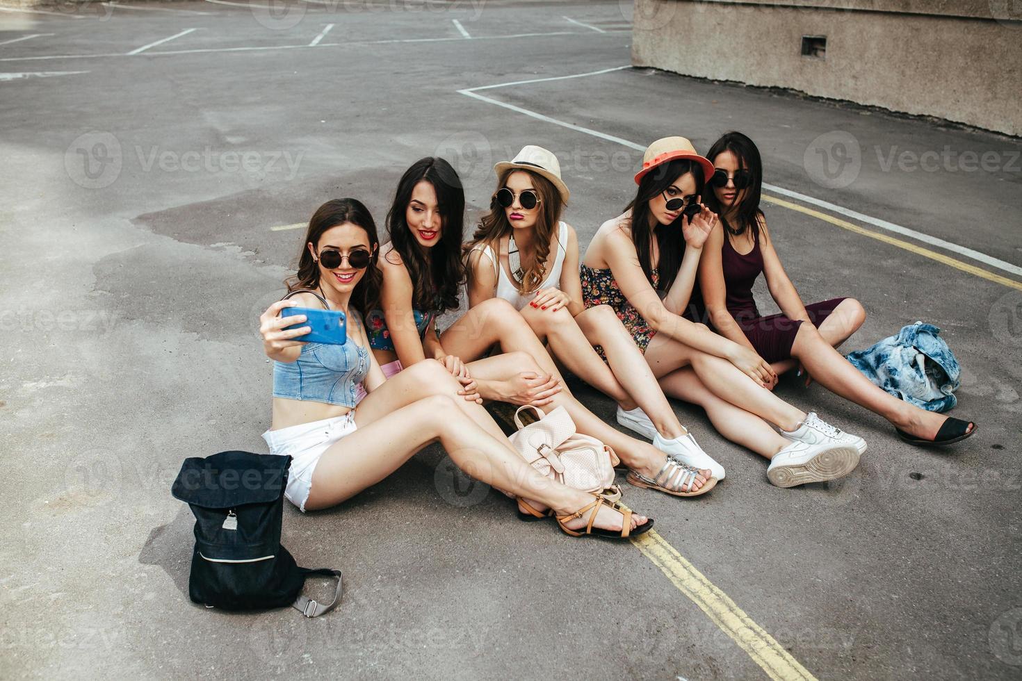 Five beautiful young girls relaxing photo