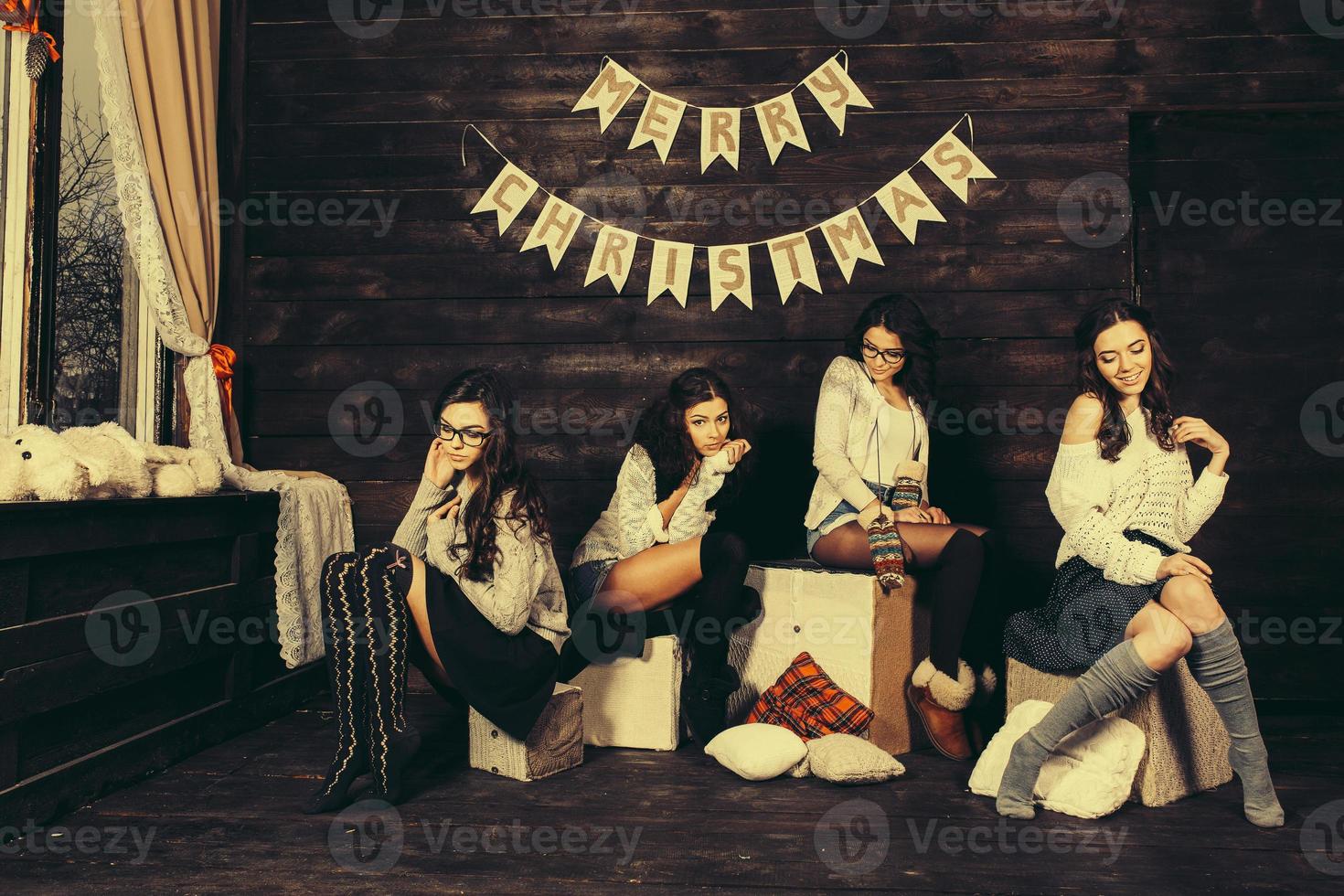 Four charming model posing on a vintage New Year's background photo