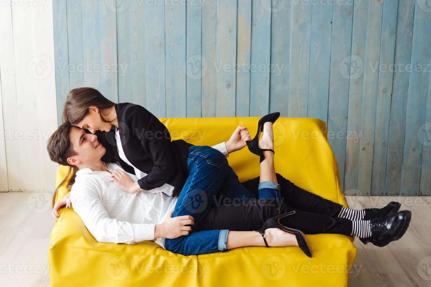 guy and girl on a yellow couch photo