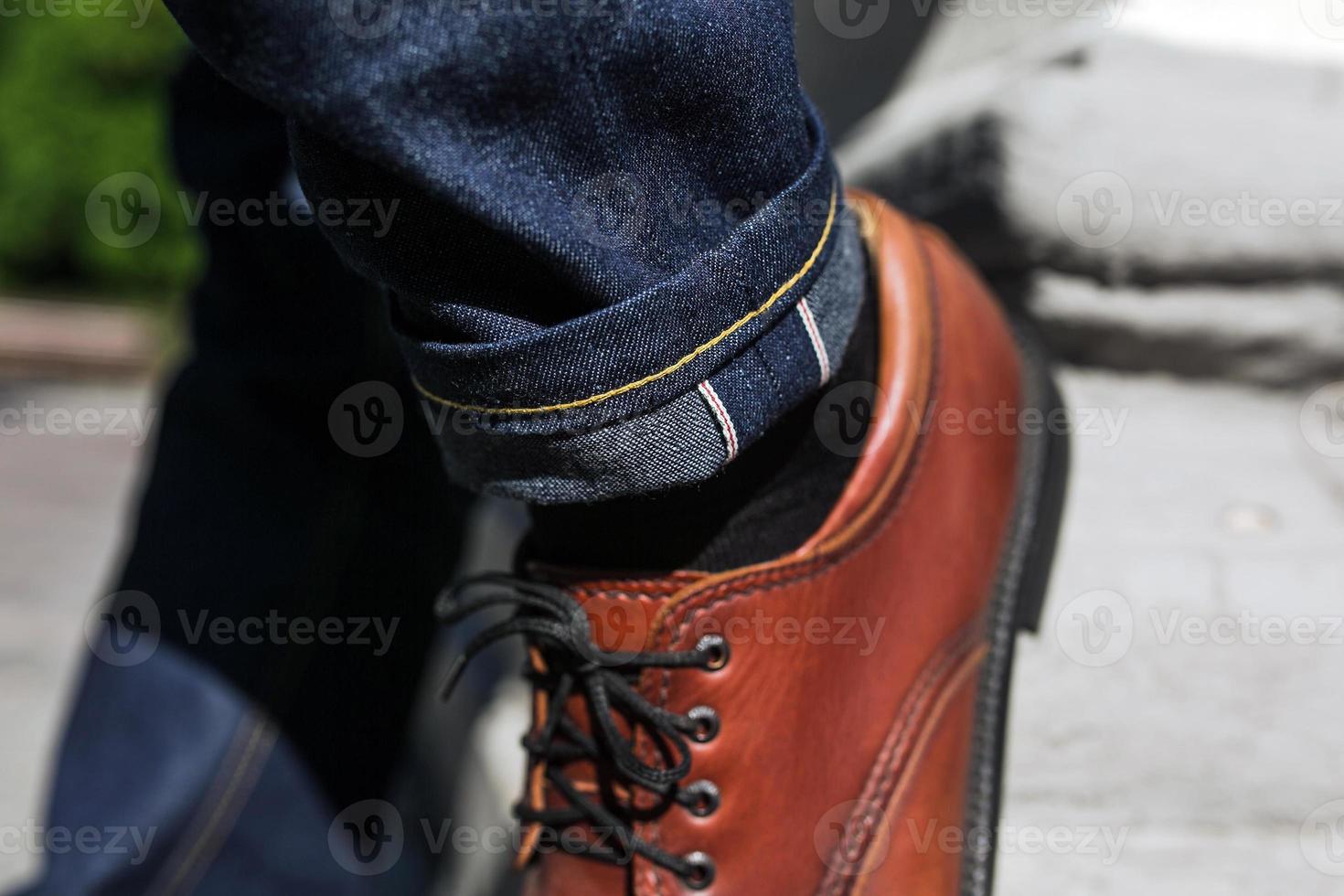 Feet of Men  in selvedge jeans and retro shoes photo