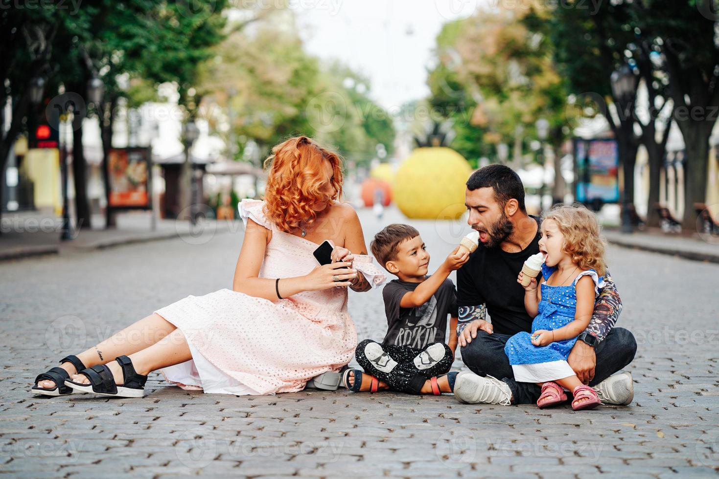 beautiful young family with ice cream photo