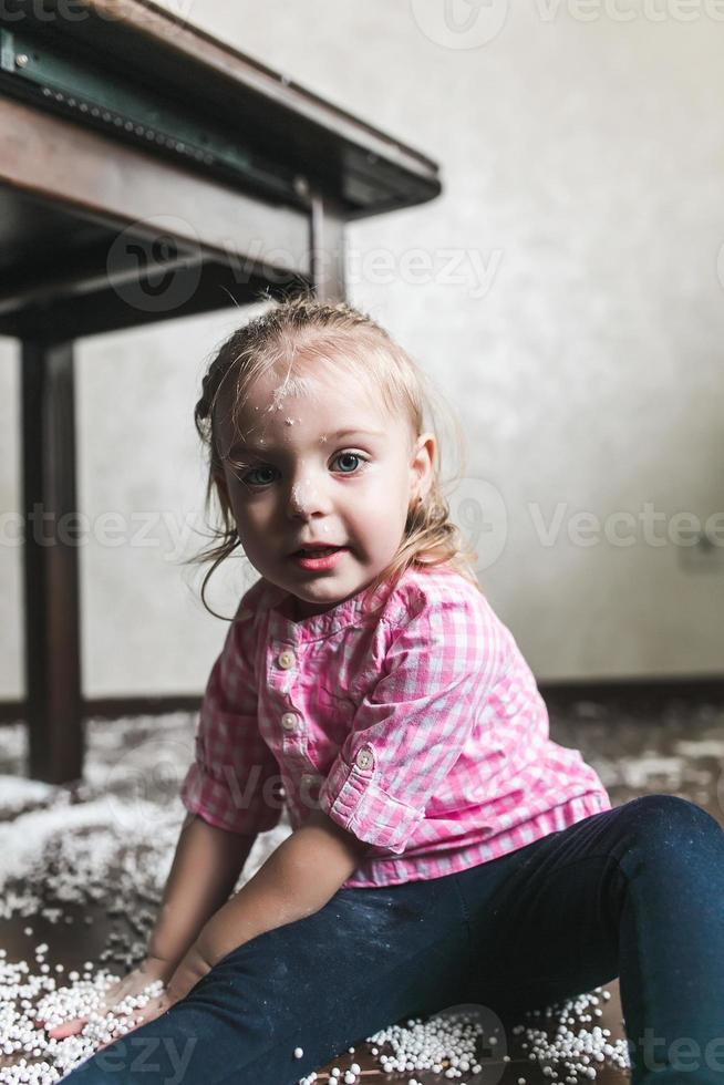 Little girl is playing with foam balls photo