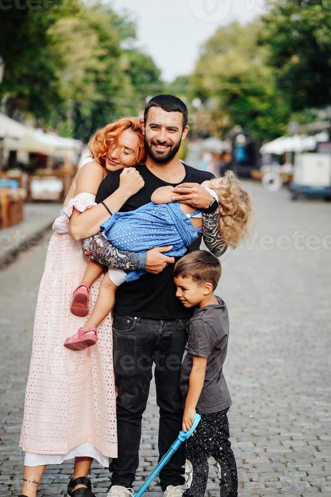 beautiful parents and their cute little kids photo