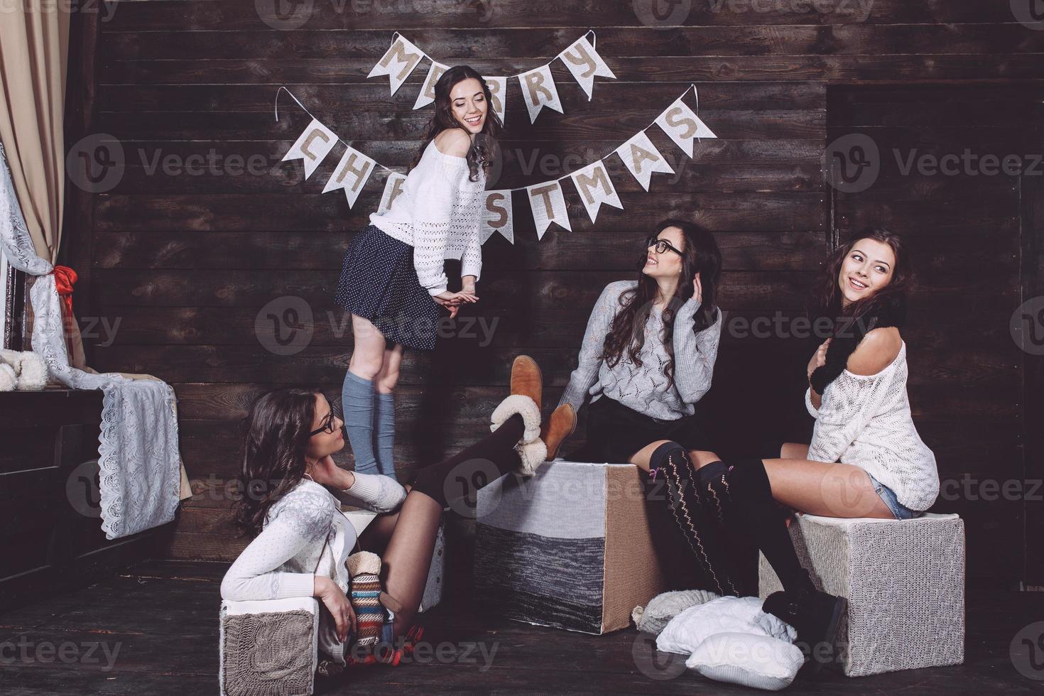 Four charming model posing on a vintage New Year's background photo