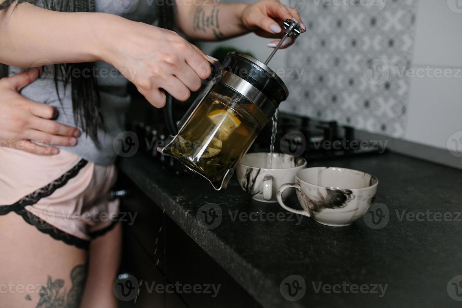 man and woman in the kitchen photo