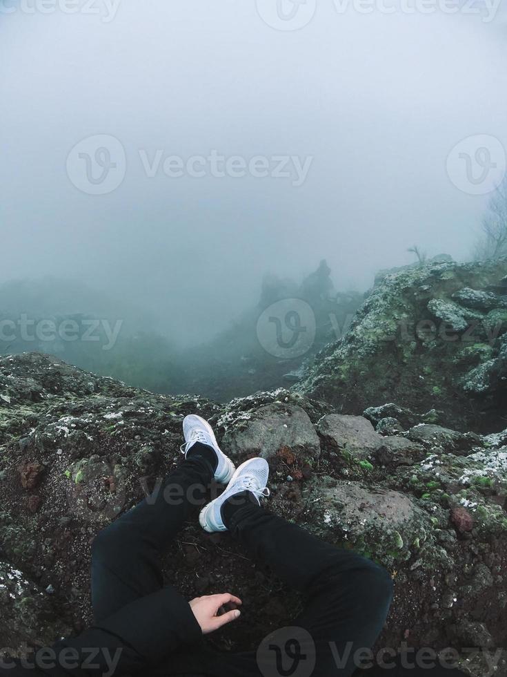 Man on cliff look at the fog photo