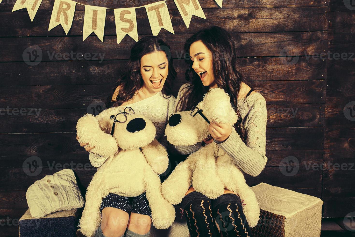 Two charming girls playing with Christmas toys photo