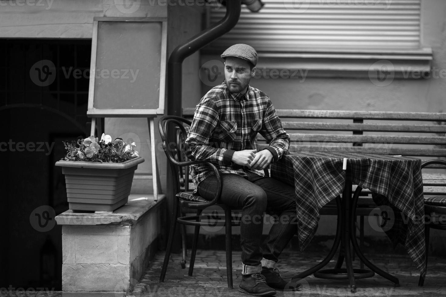 The man in the authentic boots and selvedge jeans  sitting at the table photo