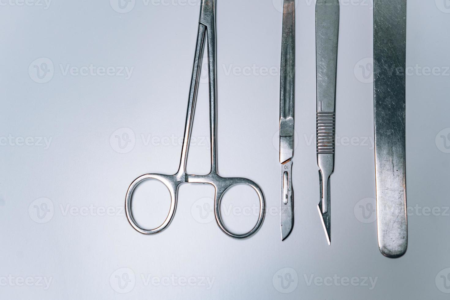 Scapula for throat, two scalpels and clamp on a light background photo