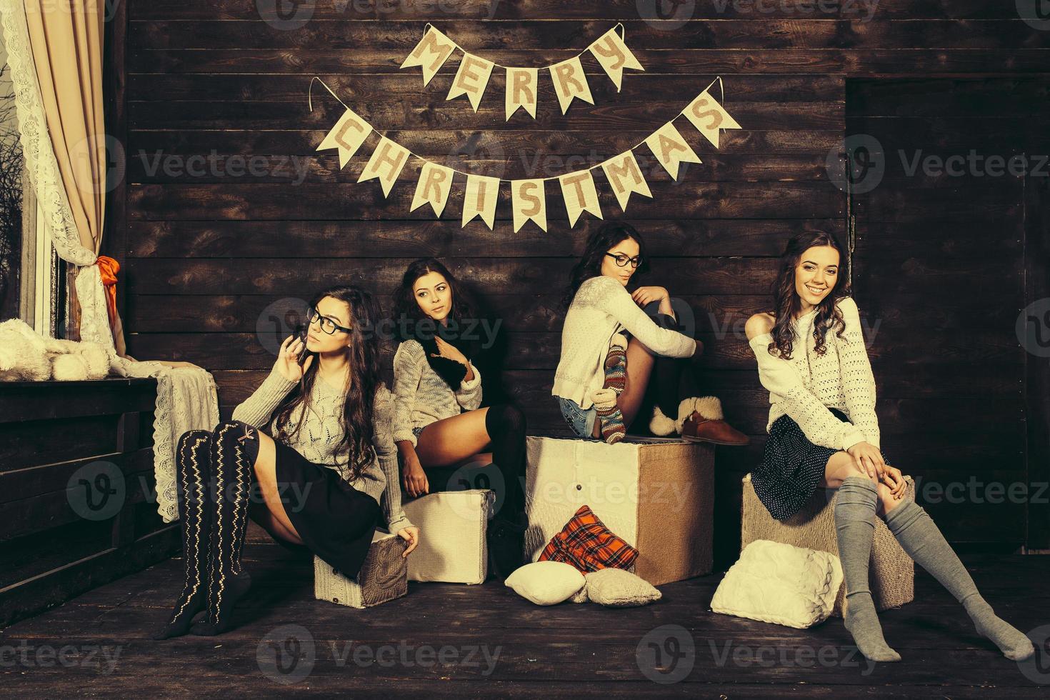 Four charming model posing on a vintage New Year's background photo