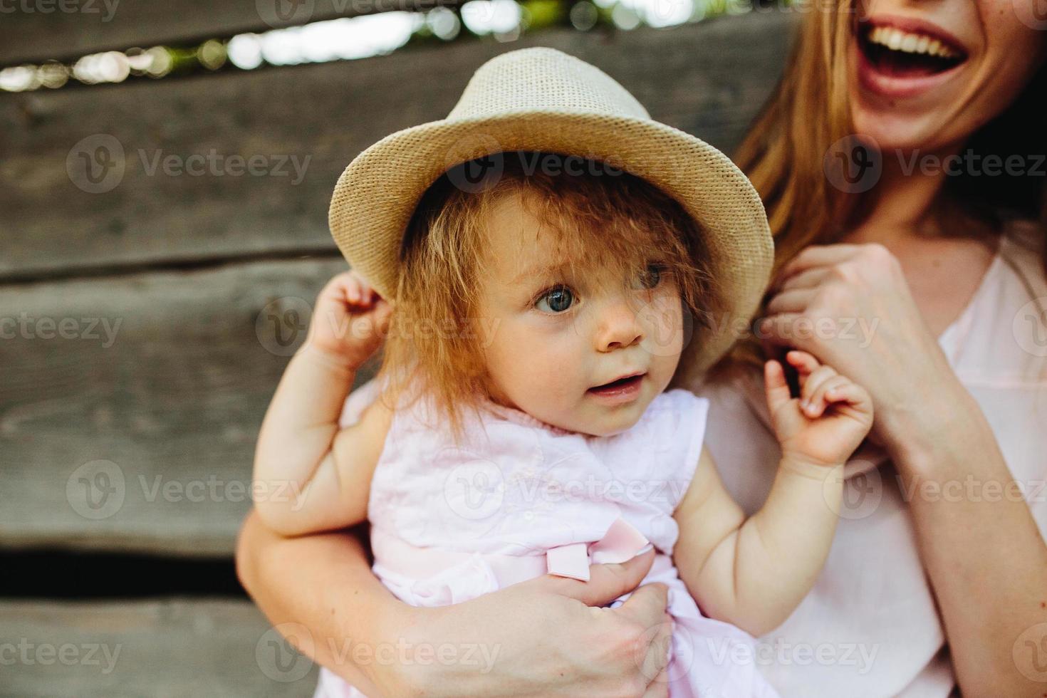 mother playing with his little daughter photo
