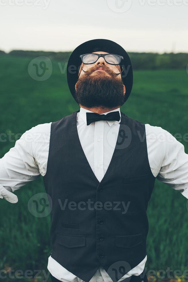 man with a beard, thinking in the field photo