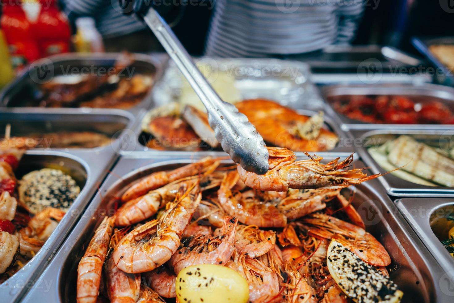 tray with many fried shrimp in the street restaurant photo