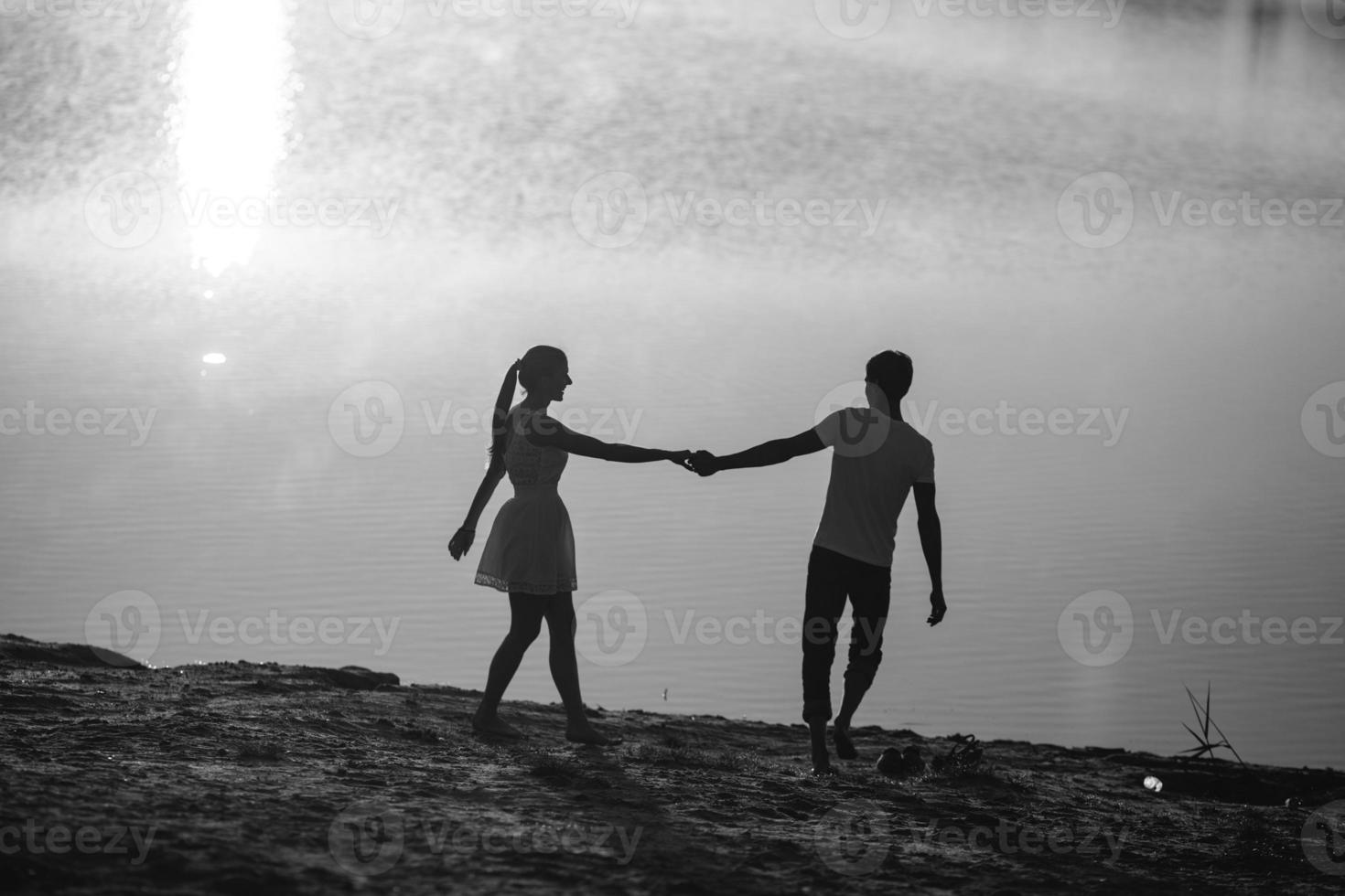 Couple in sunrise on the beach photo