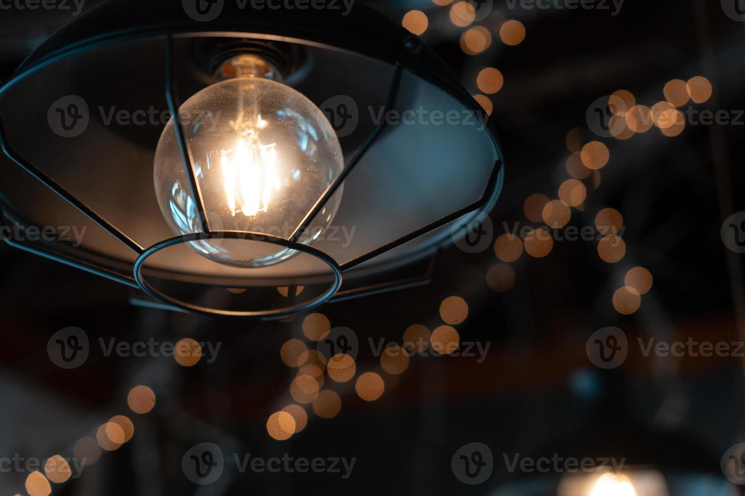 Lamp hanging outside on a dark background. photo