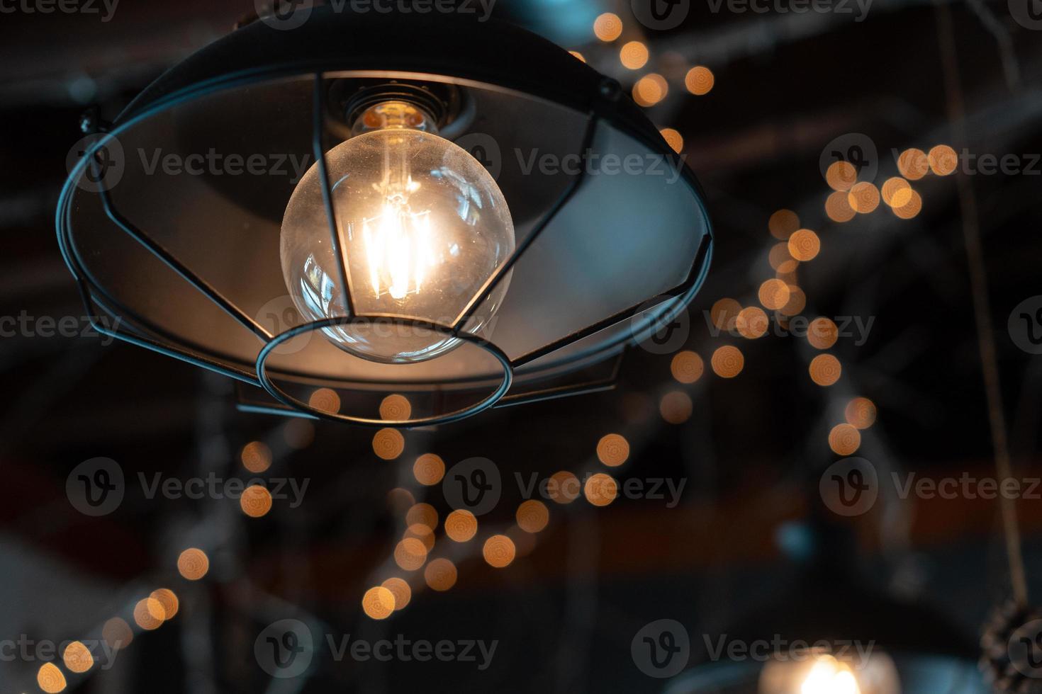 Lamp hanging outside on a dark background. photo