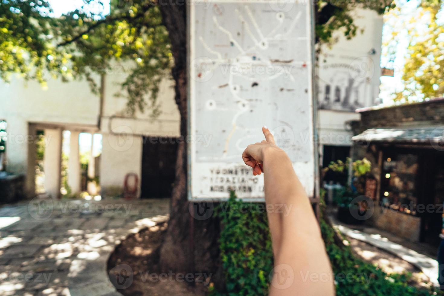 Female hand, points to the map of the city. Makrinitsa photo