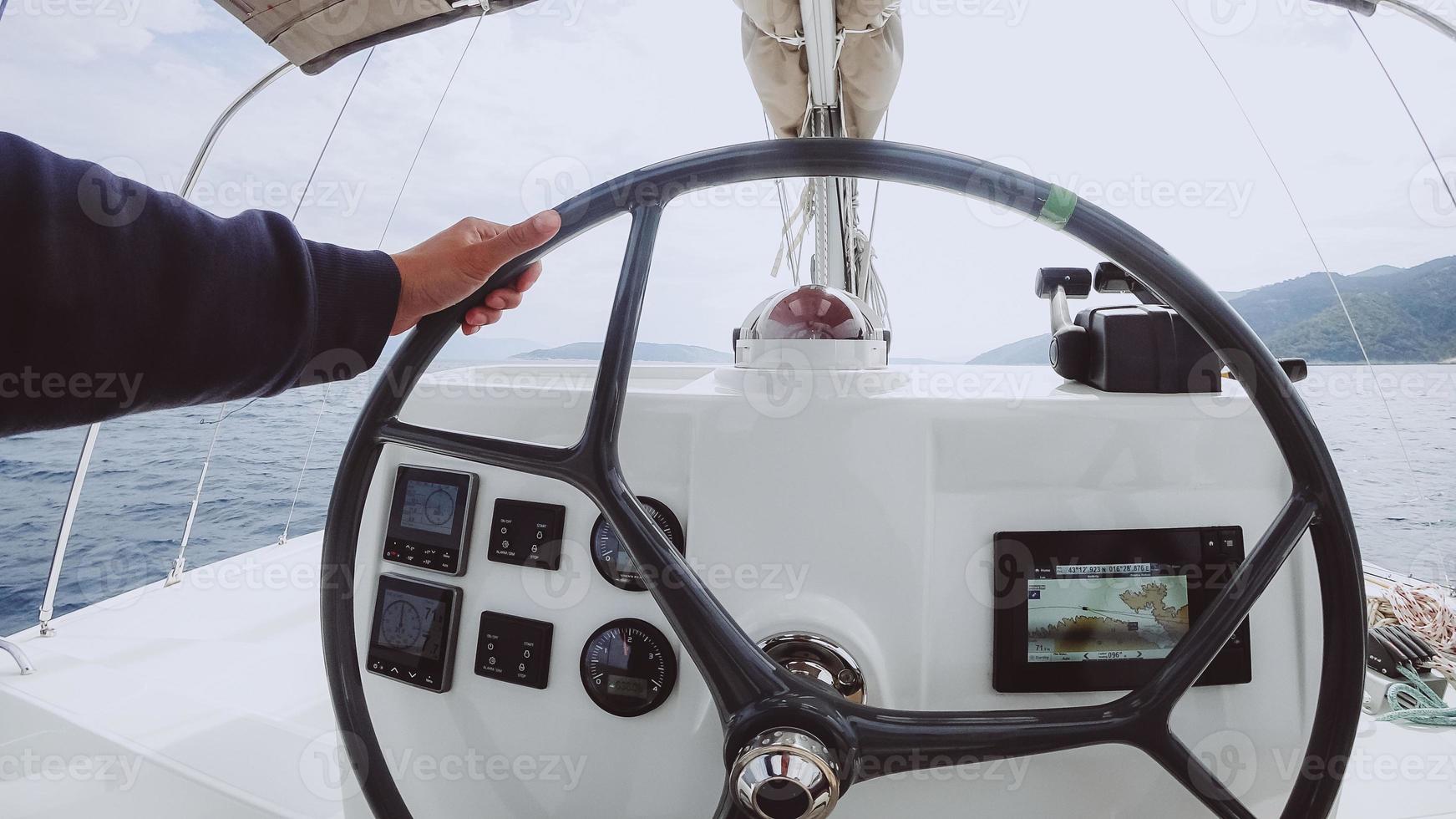 Ship control panel with steering wheel on the captain bridge photo