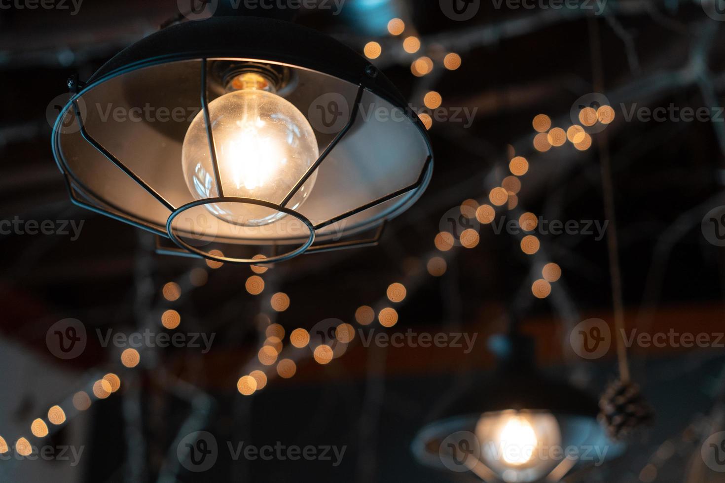 Lamp hanging outside on a dark background. photo