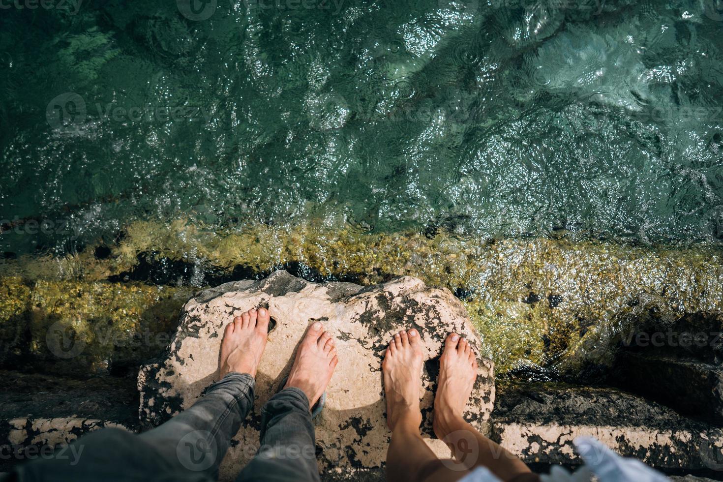 A young man and woman their legs together over a pier photo