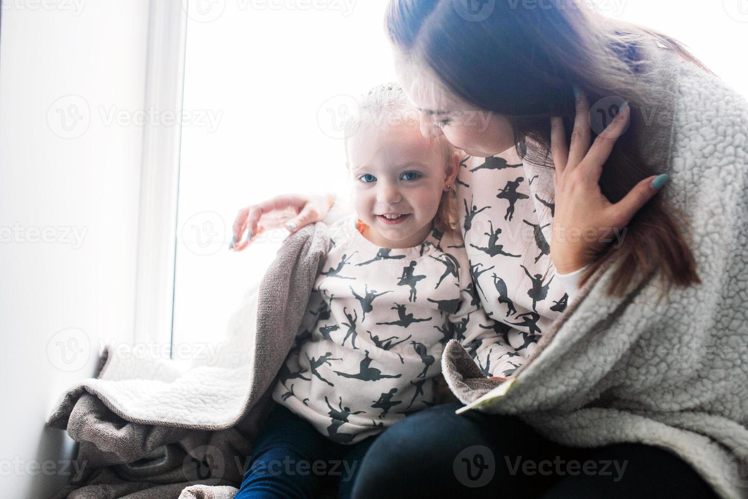 Mother and her daughter girl play in kids room photo