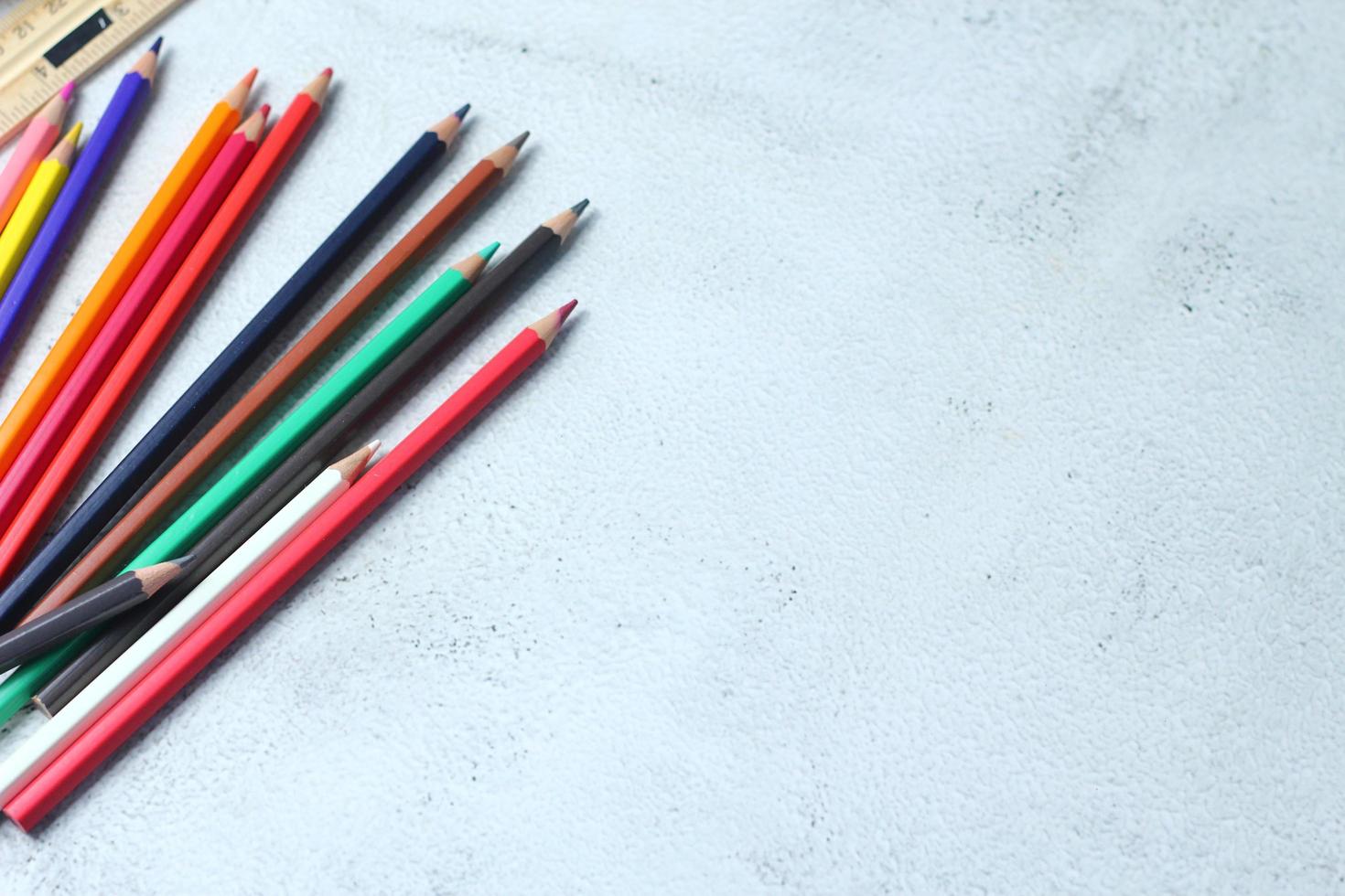 Wooden crayons scattered on the table, wooden rulers and notebooks with the festival back to the semester, students go to school, art lessons. photo