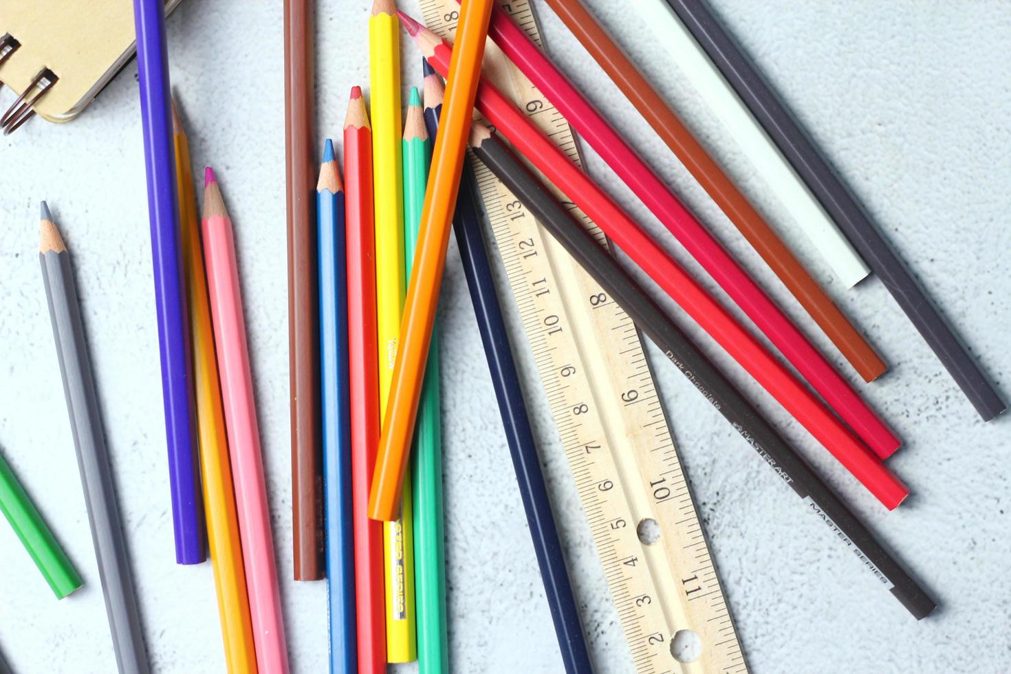 Wooden crayons scattered on the table, wooden rulers and notebooks with the festival back to the semester, students go to school, art lessons. photo
