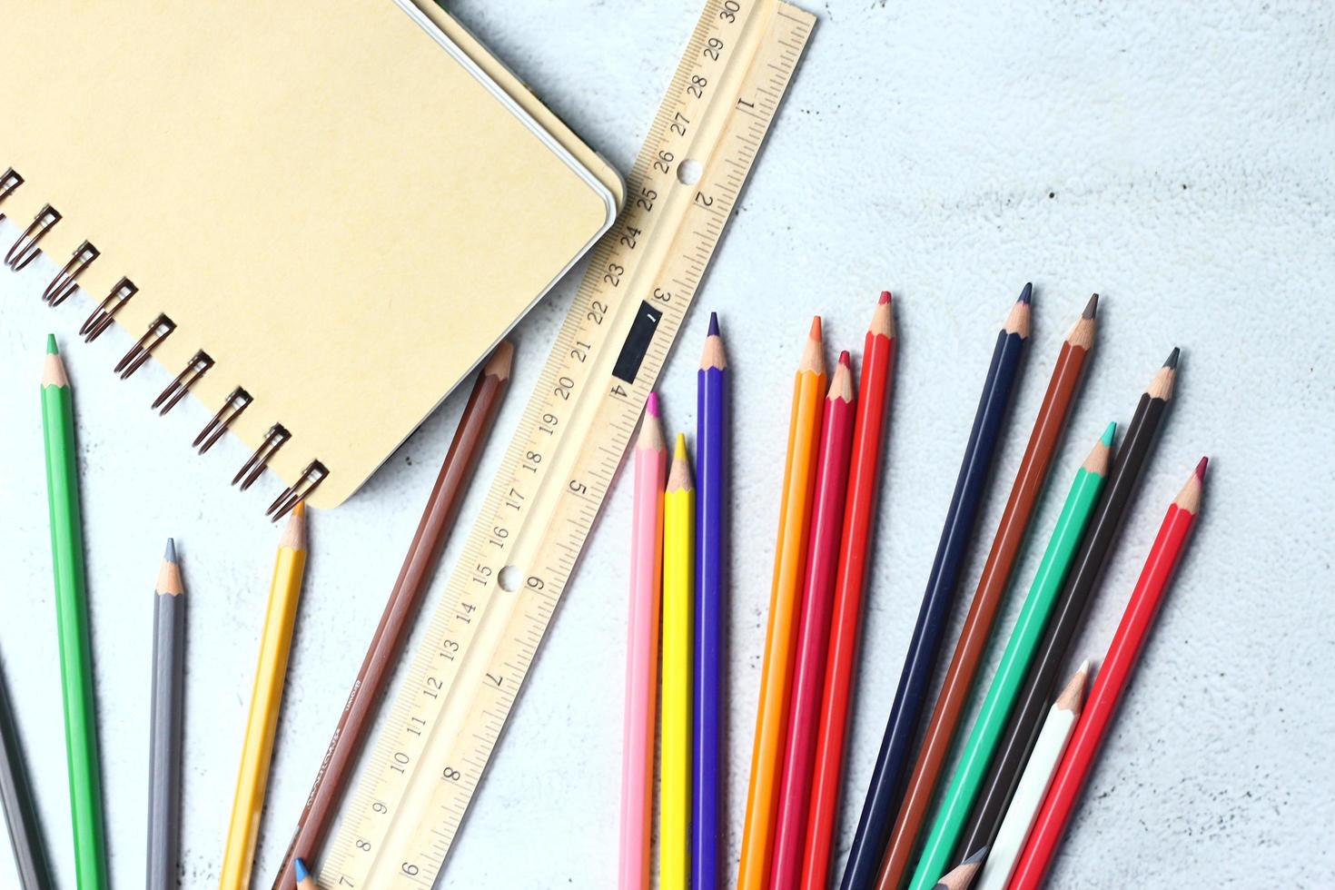 Wooden crayons scattered on the table, wooden rulers and notebooks with the festival back to the semester, students go to school, art lessons. photo