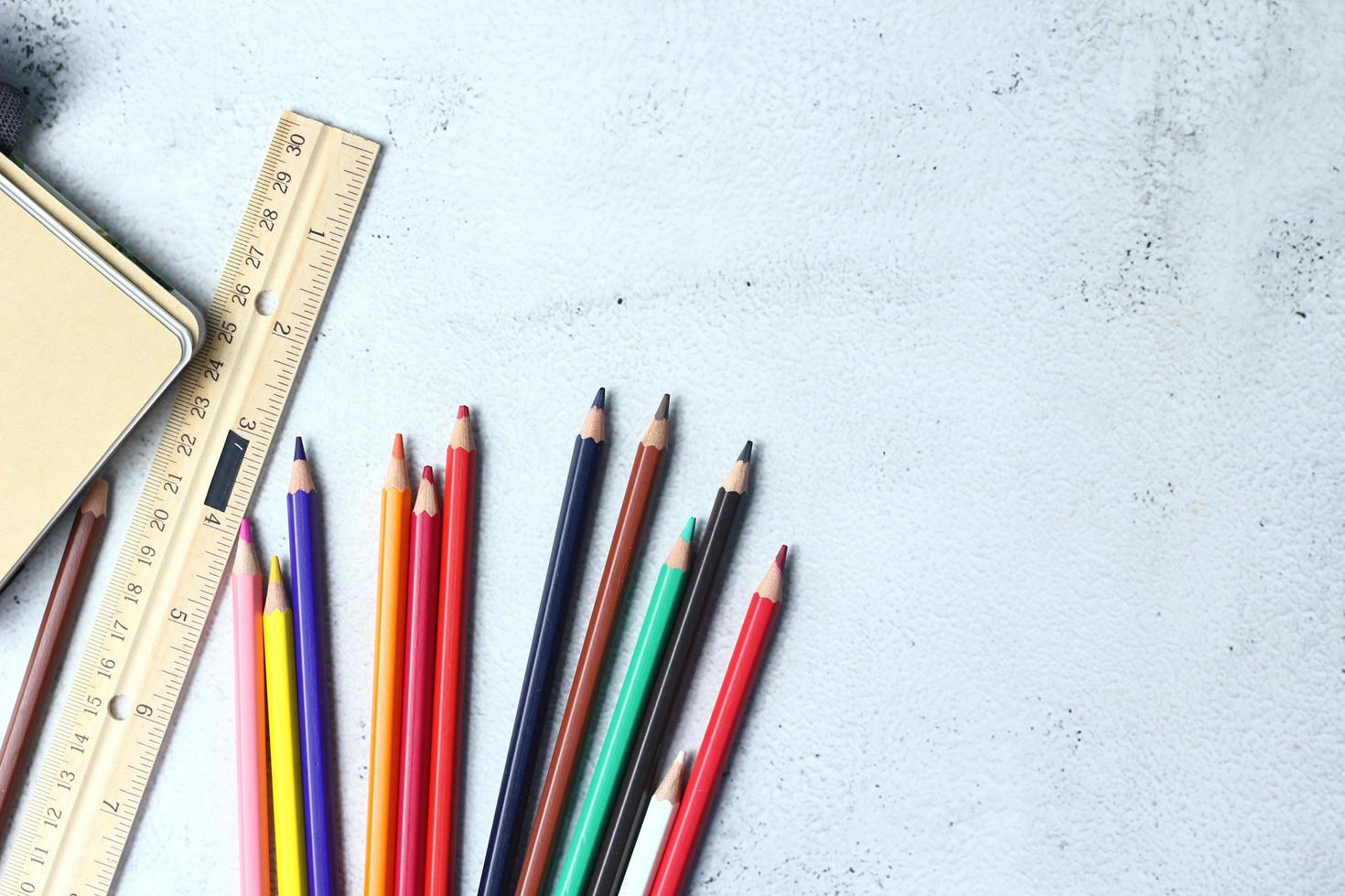 Wooden crayons scattered on the table, wooden rulers and notebooks with the festival back to the semester, students go to school, art lessons. photo