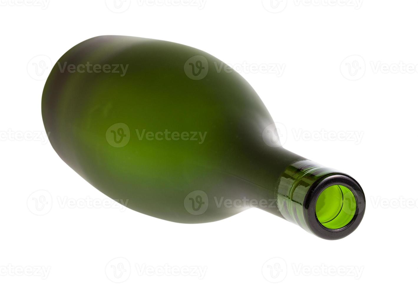 overturned empty green brandy bottle isolated photo