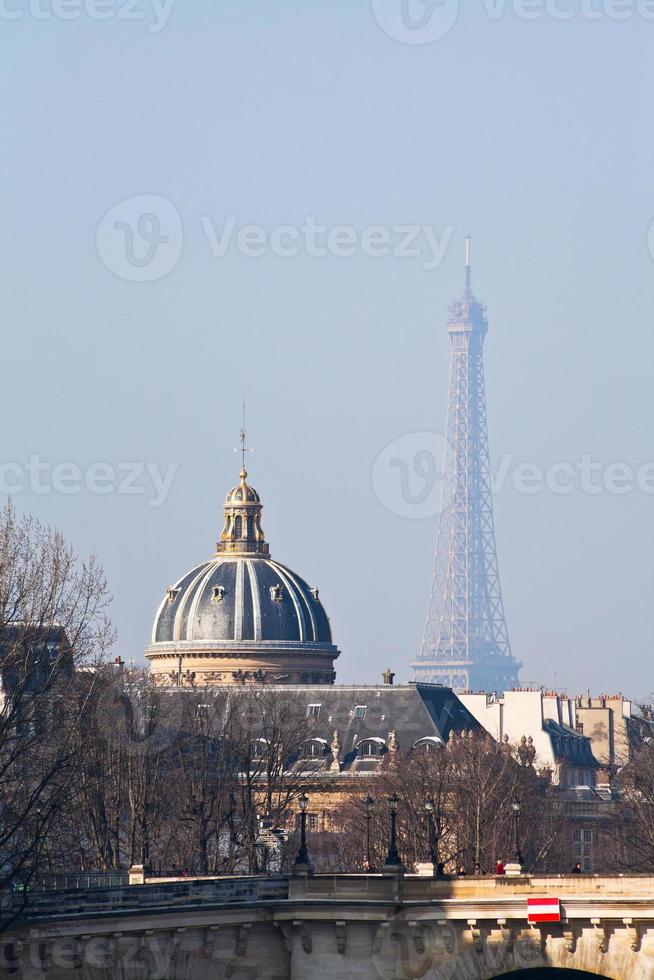 view of Eiffel Tower through Pont Neuf in Paris photo