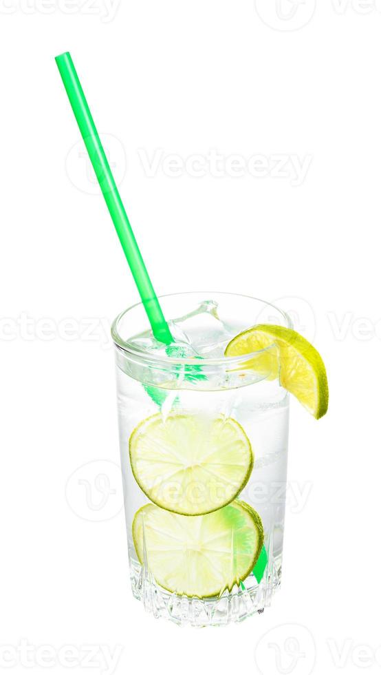 gin and tonic cocktail in glass with lime slices photo