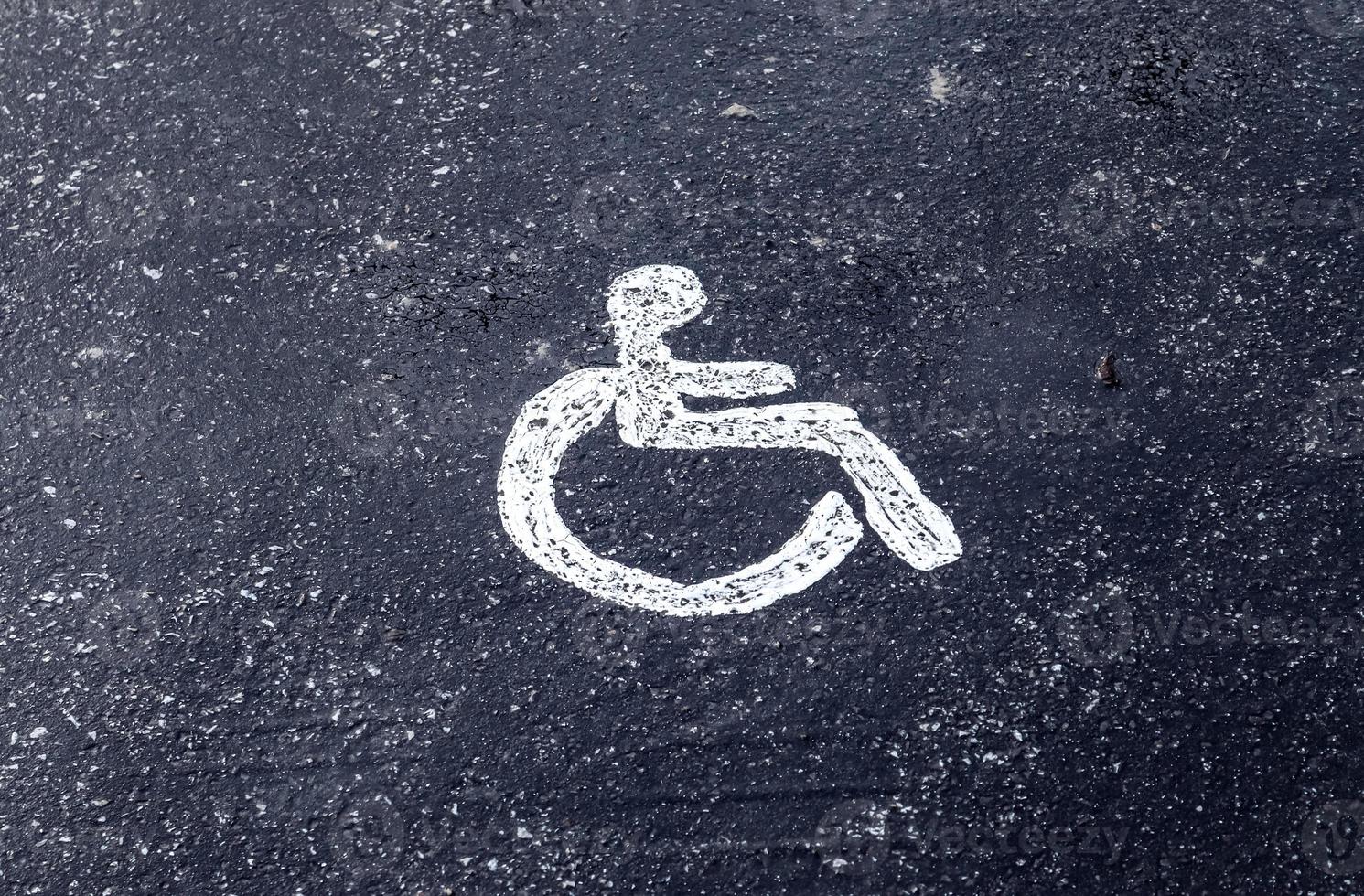 Parking spaces for disabled customers. Parking lot with painted sign of wheelchair. photo