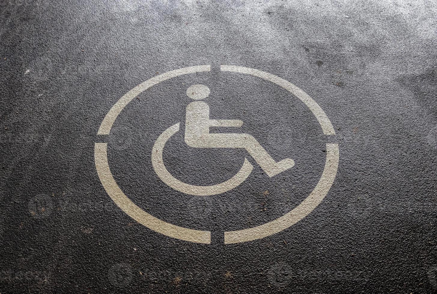 Parking spaces for disabled customers. Parking lot with painted sign of wheelchair. photo