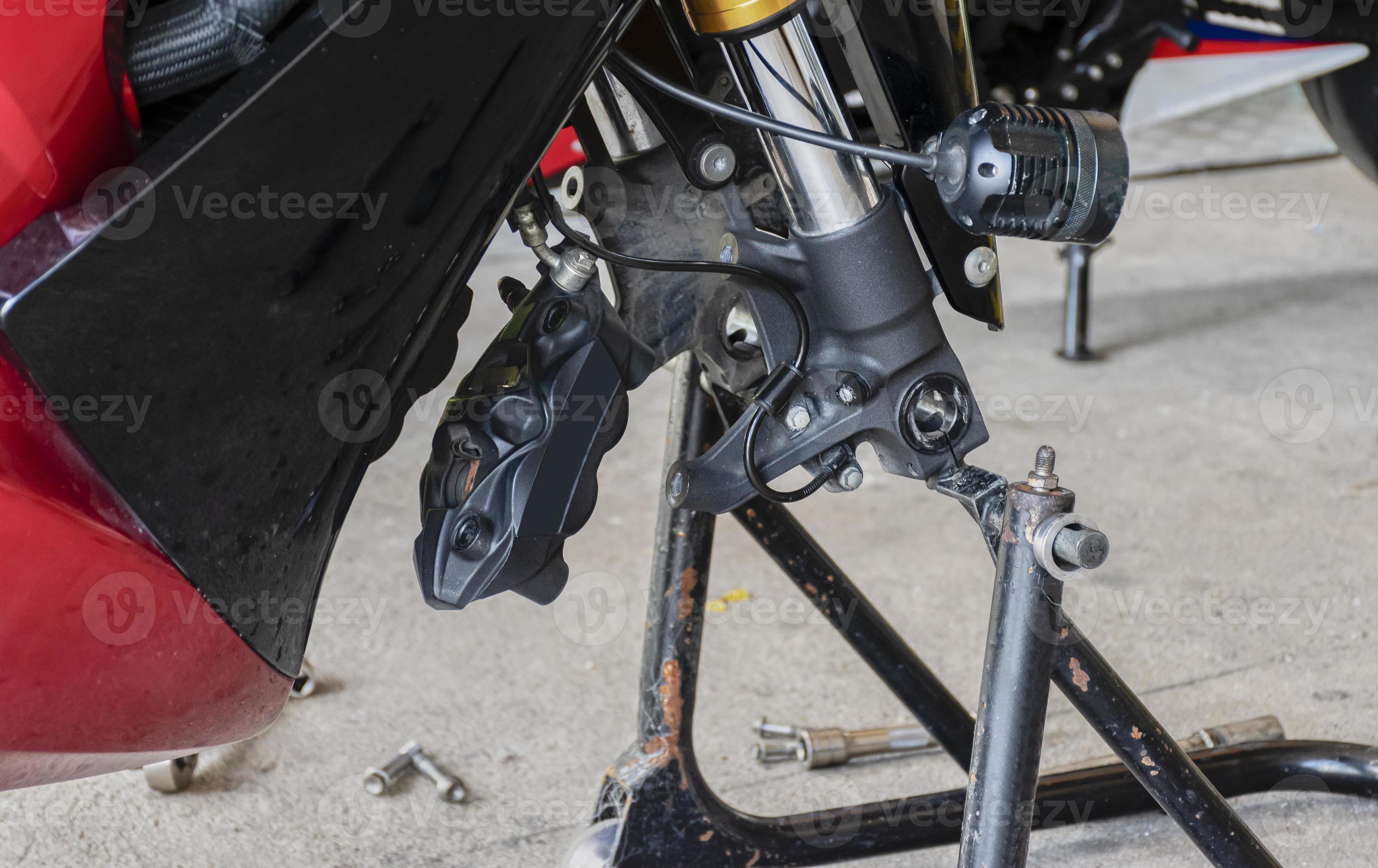 Front view motorcycle up to stand to remove wheel to change tire