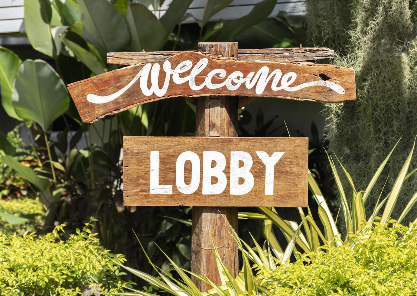 Wooden sign with message Welcome and LOBBY photo