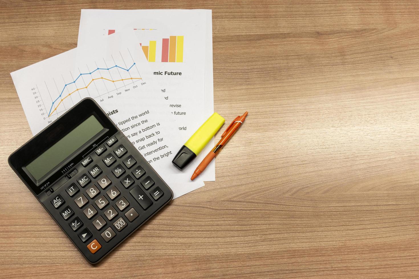 Calculator with paperwork on table photo