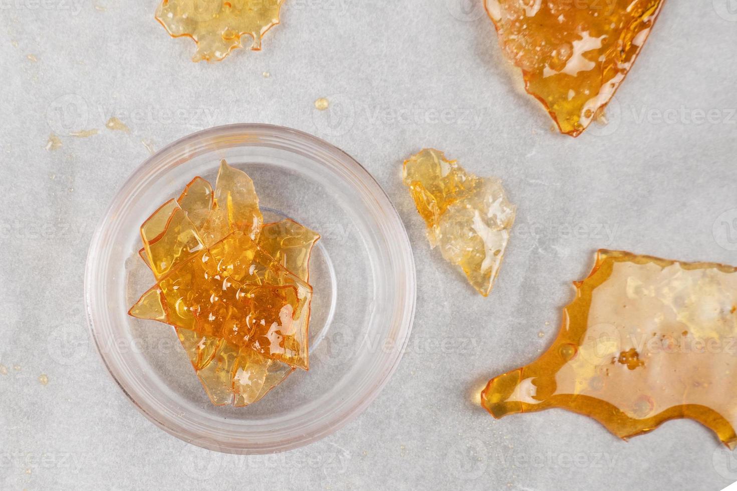 box with golden cannabis wax pieces, shatter resin photo
