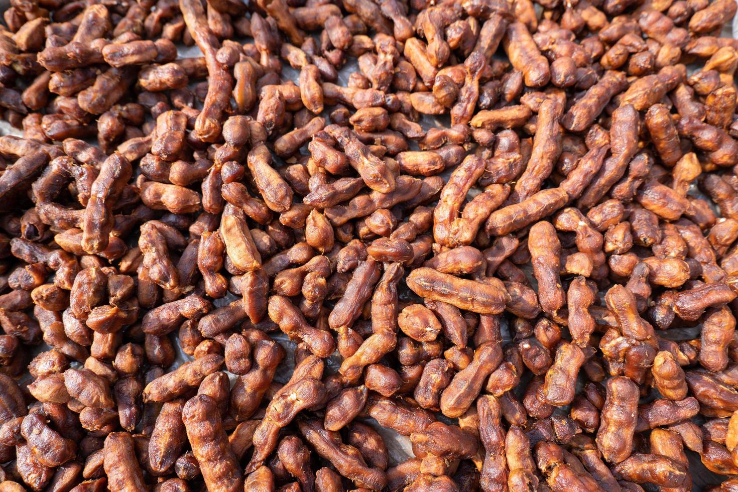 Tamarind is a food type of fruit. It is brown in color and has a sweet and sour taste. Delicious as a snack, nourishing, healthy, vitamin C. Seeds are dried together and can be used as a background. photo