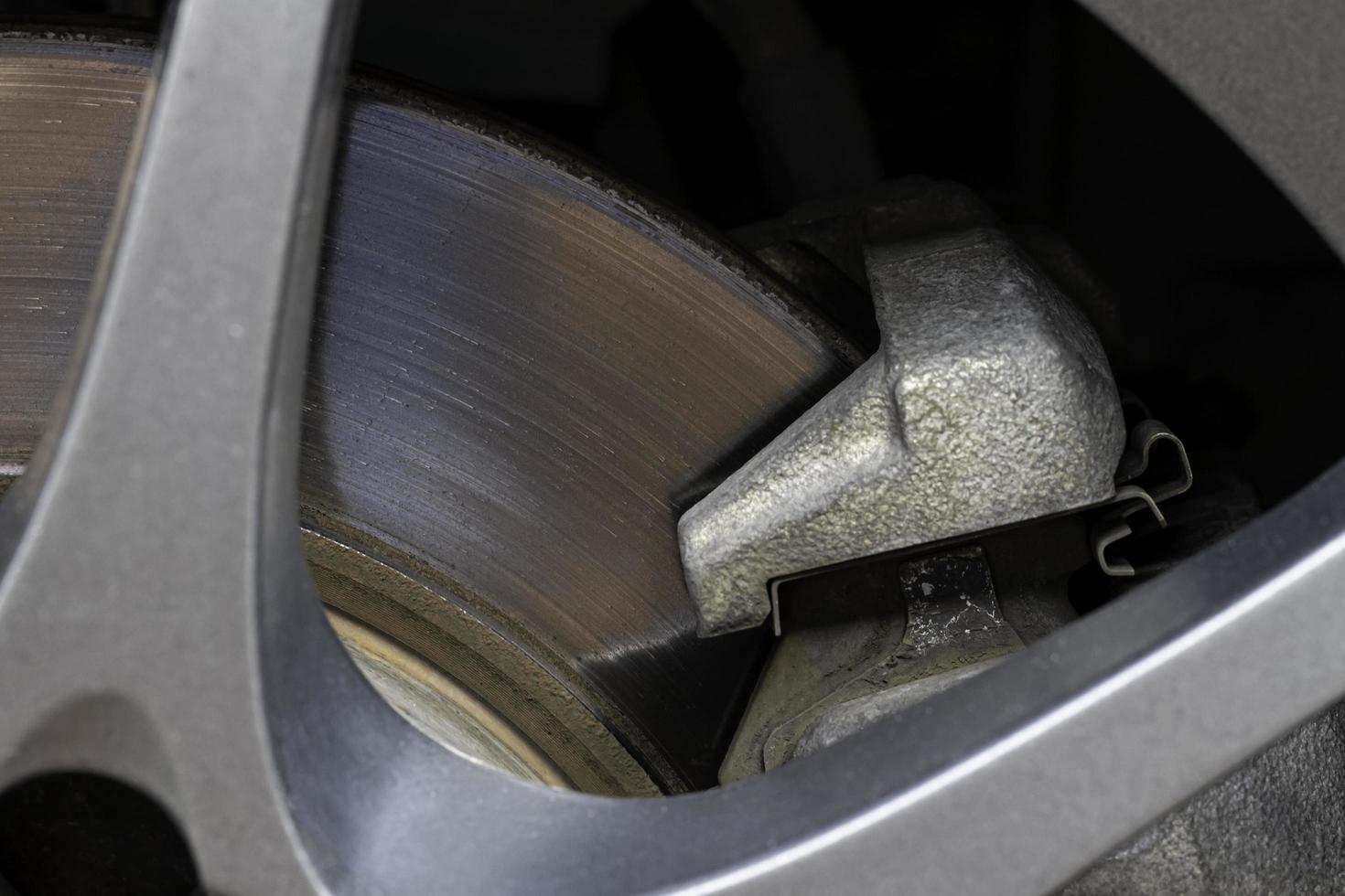 Rusted brake discs and traces of use of a small car, close-up. photo