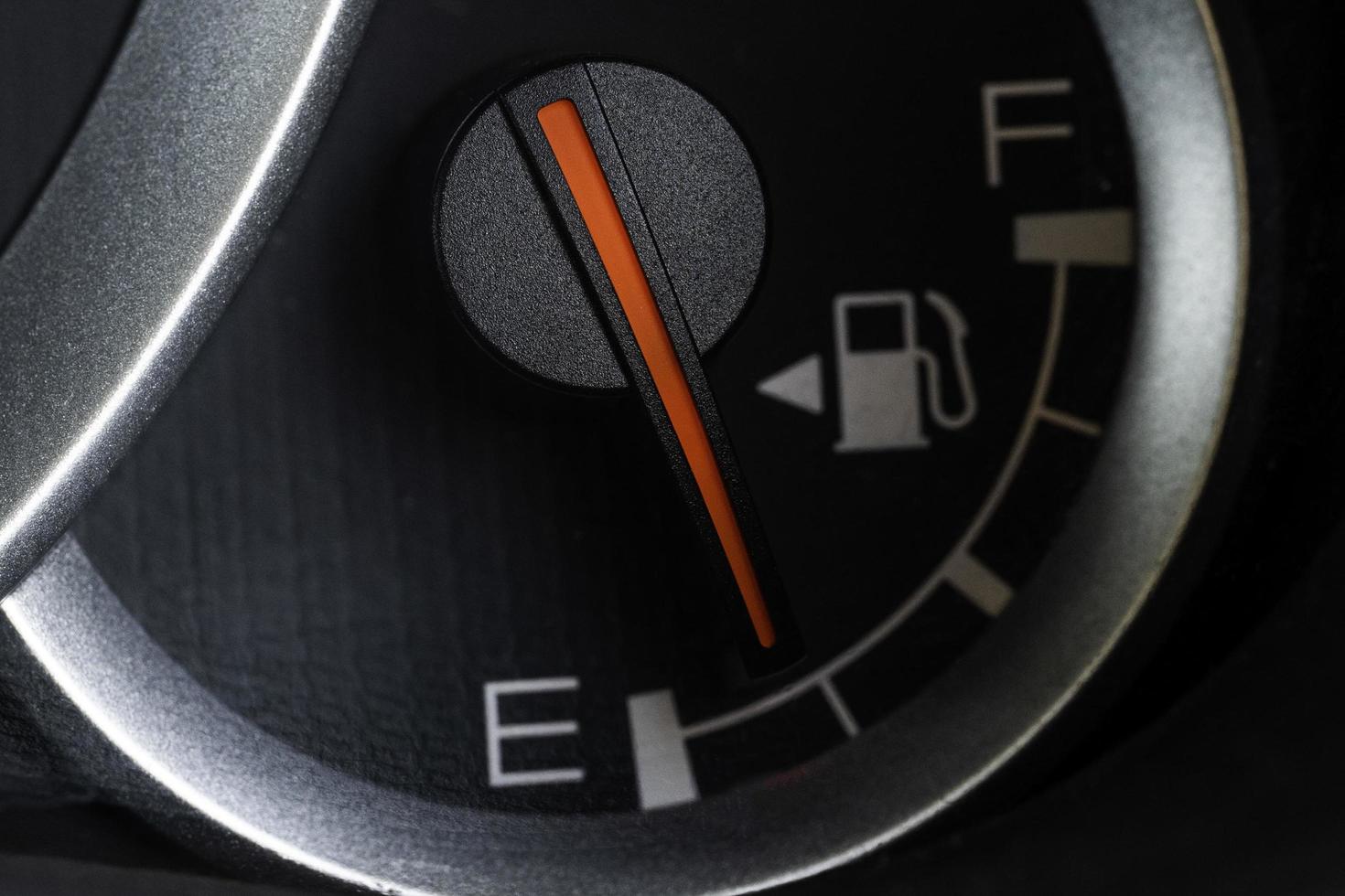 Low fuel gauge on car dashboard, close-up. photo