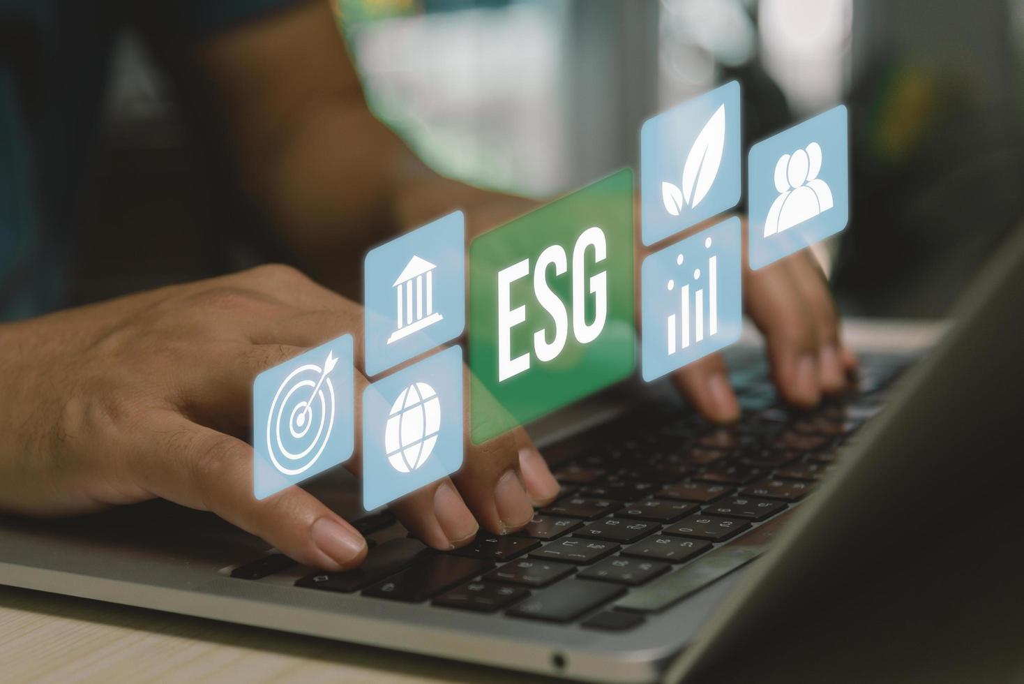ESG environment social governance investment business concept. hand using computer laptop icon symbol of esg on virtual screen concept. business investment strategy concept. photo