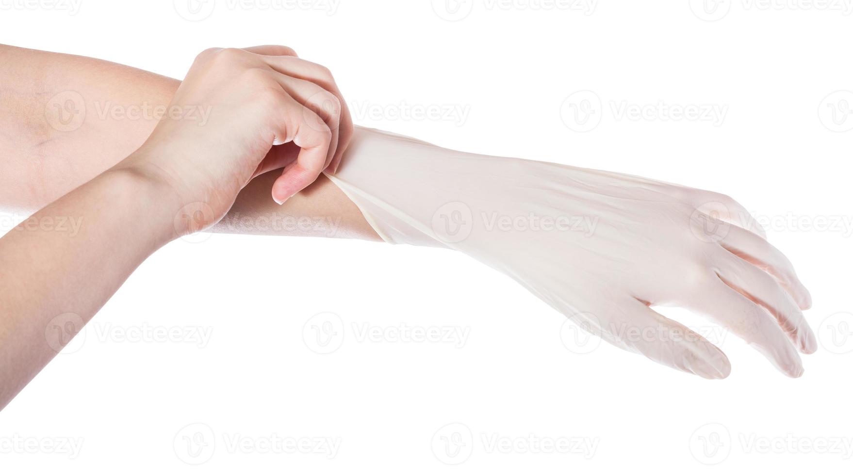 above view of hand pulls latex glove on hand photo