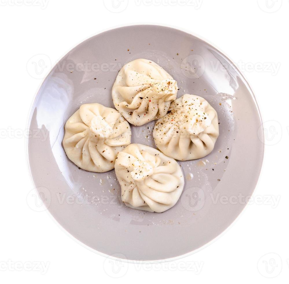top view of boiled khinkali on gray plate isolated photo