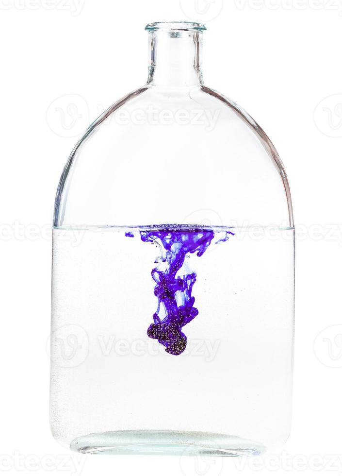 violet ink dissolves in water in flask isolated photo