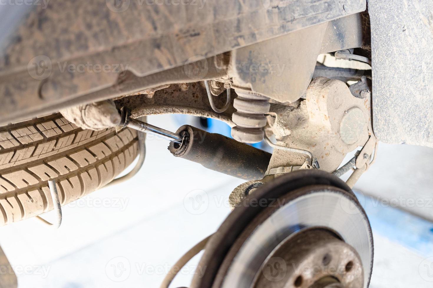 broken shock absorber on old car photo