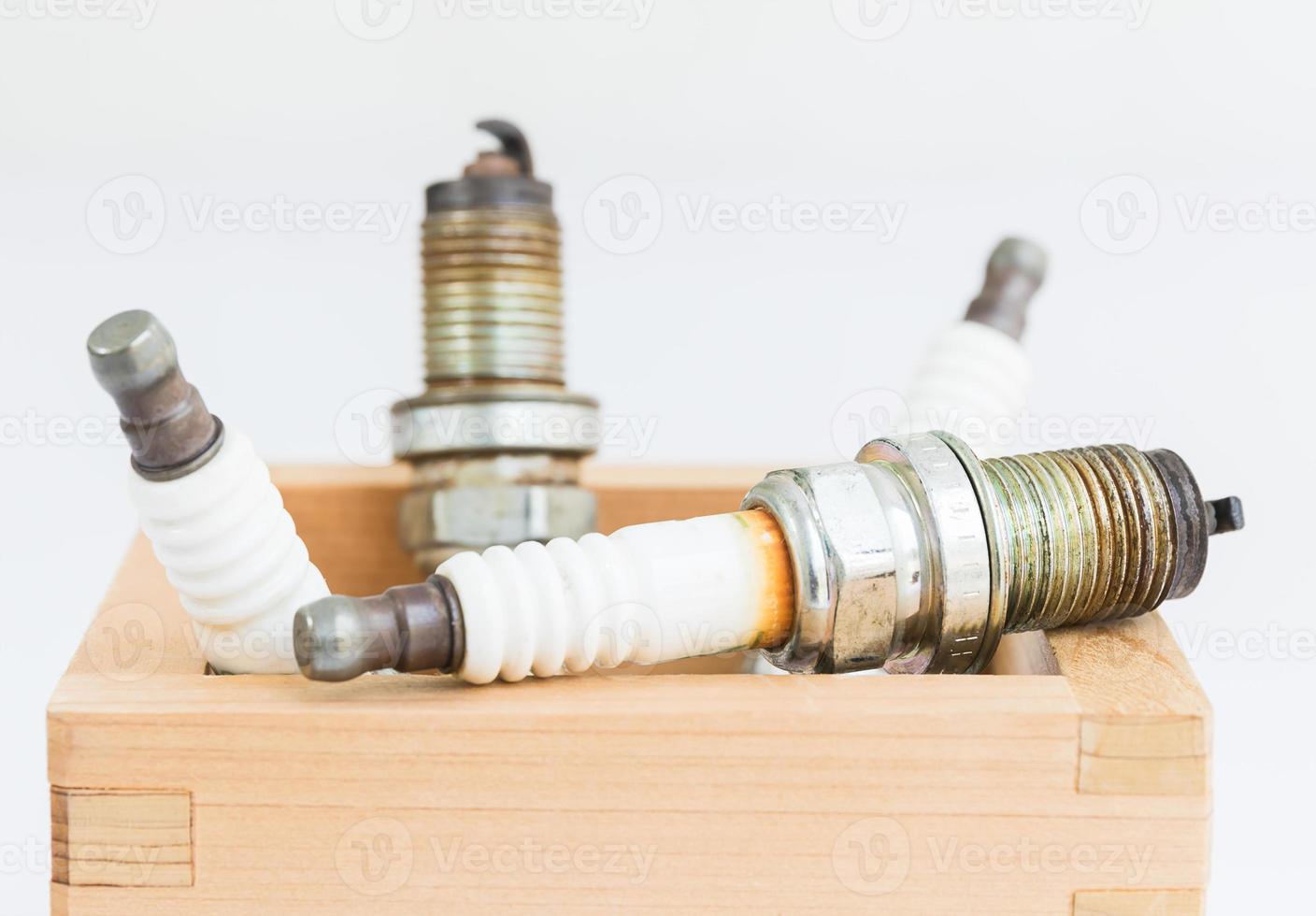 Spark plug in wood box photo