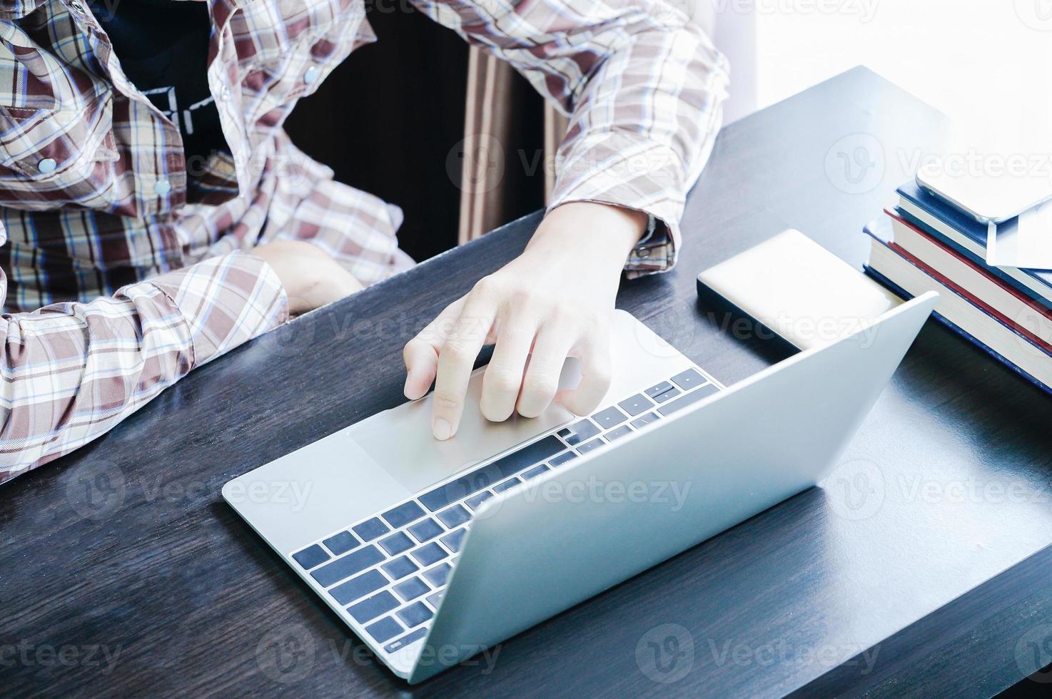 Male working with Laptop computer on the table photo