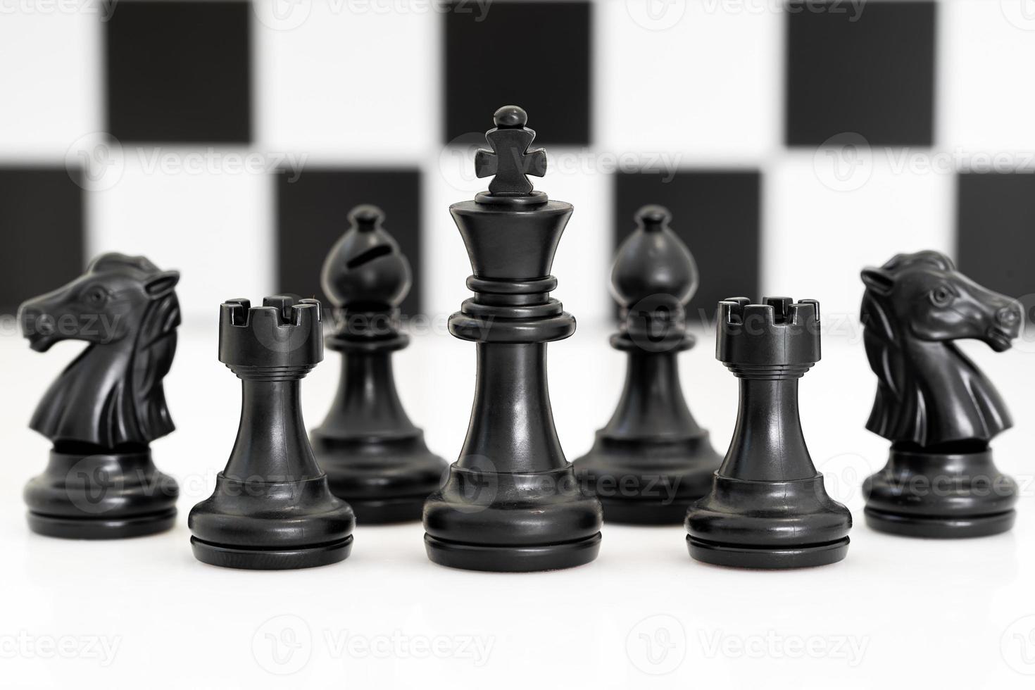 Set of Black chess pieces on white background photo