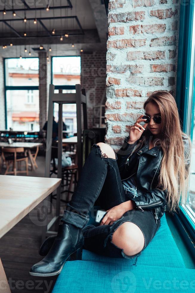Beautiful girl in sunglasses posing on camera photo